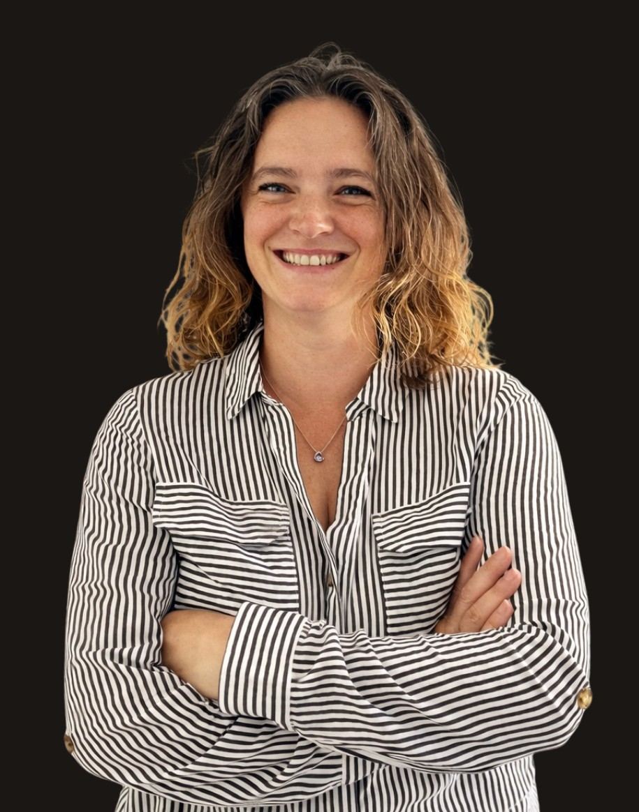 Nadine Nissen in a striped shirt against a dark background